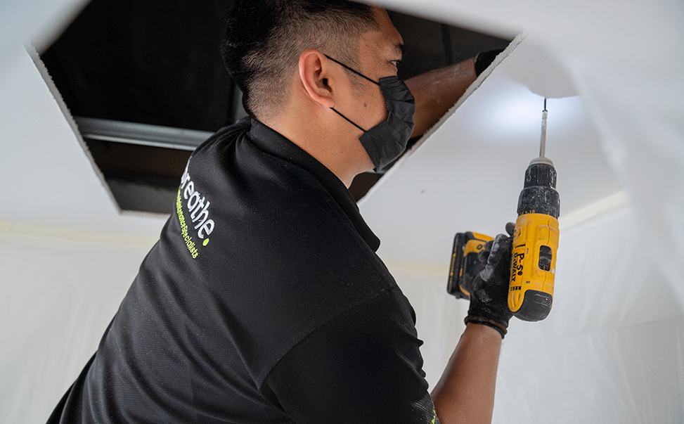 breathe-home-maintenance-specialist-2 Technician performing maintenance on a residential water tank or related system—highlighting comprehensive home services in Dubai